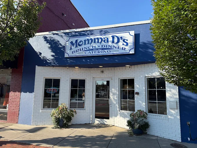 Warm, inviting interior of Momma D's restaurant in downtown Kingsport — wooden tables, soft morning light, cozy Southern atmosphere